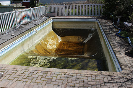 An old, worn out pool liner